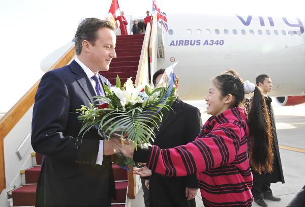 British Prime Minister David Cameron (L) is greeted upon his arrival in Beijing, capital of China, Nov. 9, 2010. [Xie Huanchi/Xinhua]