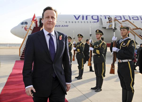 British Prime Minister David Cameron inspects an honour guard upon his arrival in Beijing, capital of China, Nov. 9, 2010.[Xie Huanchi/Xinhua]