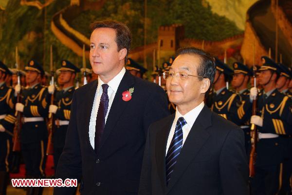 Chinese Premier Wen Jiabao (R front) and British Prime Minister David Cameron inspect the guard of honor during a welcoming ceremony in Beijing, capital of China, Nov. 9, 2010. [Yao Dawei/Xinhua]