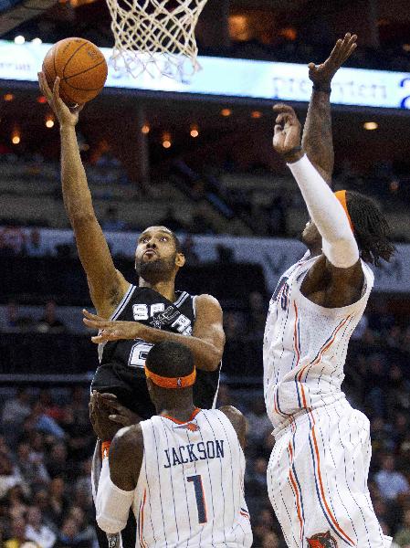 San Antonio Spurs center Tim Duncan (L) shoots against Charlotte Bobcats small forward Gerald Wallace (R) and shooting guard Stephen Jackson (1) during their NBA basketball game in Charlotte, North Carolina November 8, 2010. (Xinhua/Reuters Photo)