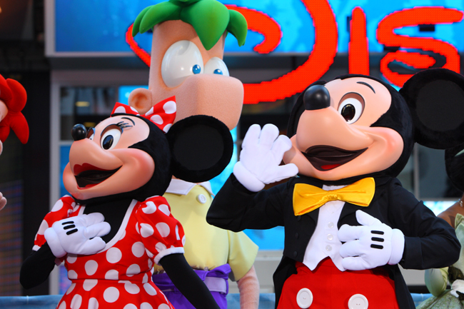 Mickey Mouse and Minnie Mouse pose during the opening ceremony of the new Time Square Disney Store in New York, Nov 9, 2010. [Xinhua]