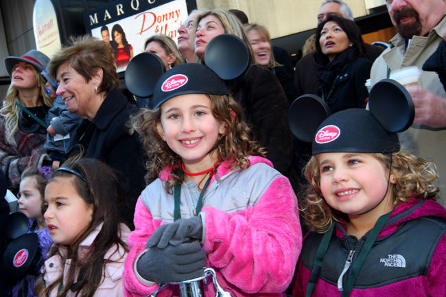 Children watch the grand opening celebration of the premier Disney Store on Tuesday, Nov 9, 2010, in Times Square, New York. [Xinhua]