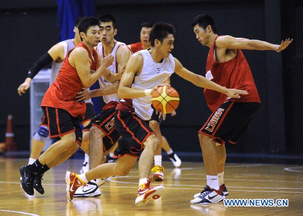 Players of China's national men's basketball team act during a training session for the coming Guangzhou Asian Games in Beijing, capital of China, Nov. 9, 2010. (Xinhua/Luo Xiaoguang)