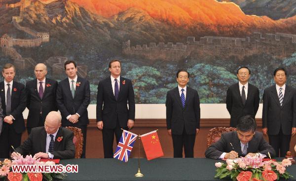 Chinese Premier Wen Jiabao (3rd R Back) and British Prime Minister David Cameron (4th L Back) attend the signing ceremony of documents between the two countries in Beijing, capital of China, Nov. 9, 2010. [Xinhua]