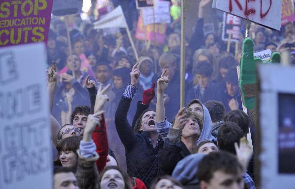 Demonstrators protest outside the Conservative Party headquarters building in central London November 10, 2010. [Xinhua]