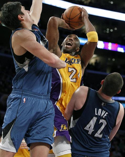 Los Angeles Lakers' Kobe Bryant (C) goes up to score between Minnesota Timberwolves' Darko Milicic of Serbia (L) and Kevin Love during their NBA basketball game in Los Angeles, California November 9, 2010. Lakers won 99-94. (Xinhua/Reuters Photo)