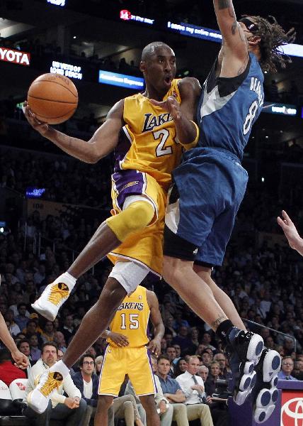 Los Angeles Lakers' Kobe Bryant (L) goes up to shoot past Minnesota Timberwolves' Michael Beasley during their NBA basketball game in Los Angeles, California November 9, 2010. (Xinhua/Reuters Photo)