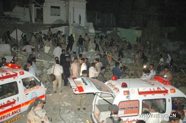 Ambulances park at the blast site in southern Pakistani port city of Karachi on Nov. 11, 2010. At least 30 people were killed and 150 others injured in a powerful blast that went off Thursday night in the downtown area of Karachi, the largest industrial city in southern Pakistan. [Arshad/Xinhua]