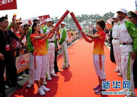 Famous Table Tennis athlete and No.128 torchbearer Liu Shiwen(R) hands over the torch with Zhang Ziyi(L), the nationwide well-known actress in China.   