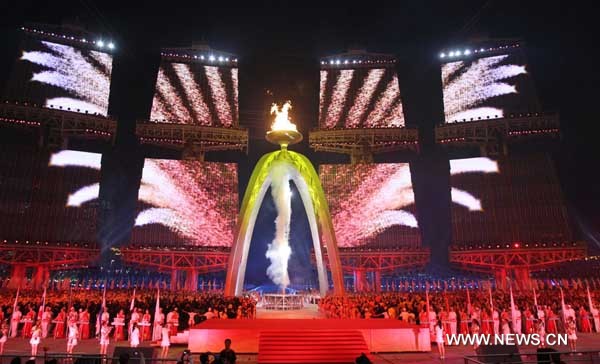 Main cauldron is lit during the art performance of opening ceremony at the 16th Asian Games at the Haixinsha Island in Guangzhou, China, Nov. 12, 2010. (Xinhua/Fan Jun)