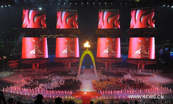 The main cauldron is lit up during opening ceremony at the 16th Asian Games at the Haixinsha Island in Guangzhou, China, Nov. 12, 2010. (Xinhua/Guo Yong)