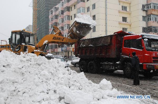 A snow clearer works on a street in Harbin, capital of northeast China's Heilongjiang Province, Nov. 12, 2010. A heavy snow hit the city from late Thursday. 