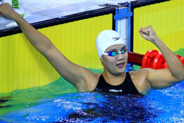 Zhu Qianwei of China celebrates after women's 200m freestyle final of swimming at the 16th Asian Games in Guangzhou, south China's Guangdong Province, Nov. 13, 2010. Zhu Qianwei claimed the title with 1 minute 56.65 seconds. (Xinhua/Chen Jianli) 
