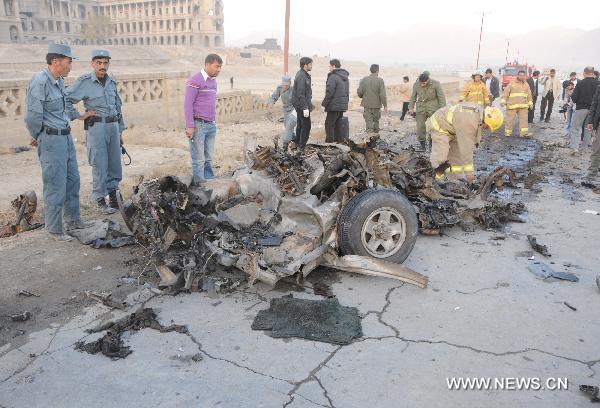 Policemen and fire fighters inspect the site of suicide car bombing in Kabul, capital of Afghanistan, Nov. 12, 2010. A suicide car bomb blast targeting foreign troop's convoy in Kabul on Friday left the attacker dead and an Afghan National Army soldier injured. [Xinhua/Wang Yan]