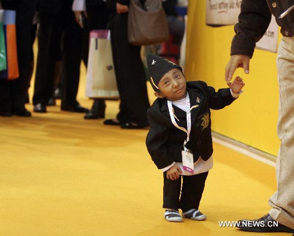 Nepalese world's shortest man Khagendra Thapamagar attends a promotion of Nepalese tourism in London, capital of Britain, Nov. 11, 2010. Measuring 67.08 cm tall and 5.5 kilograms in weight, 18-year old Khagendra Thapamagar has been confirmed by the Guiness World Records to be the world's shortest adult man this year.