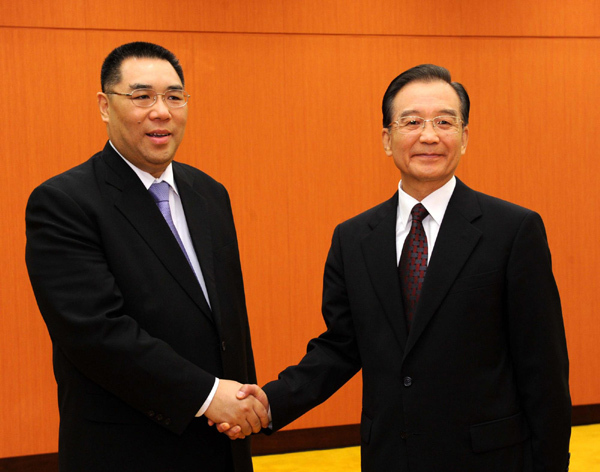 Chinese Premier Wen Jiabao (R) shakes hands with Chief Executive of the Macao Special Administrative Region Chui Sai On in Macao on Saturday afternoon. [Xinhua]