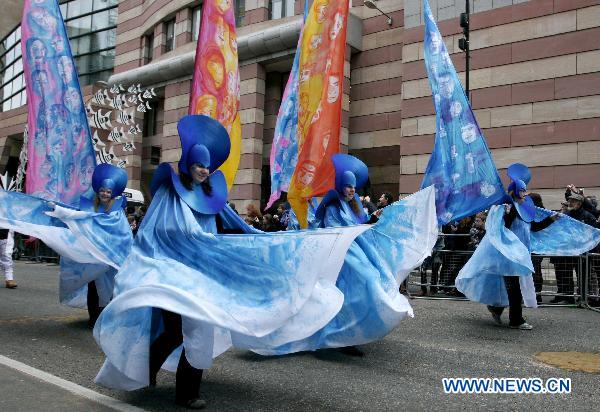 Costumed performers dance during the Lord Mayor&apos;s Show in the City of London, capital of Britain, Nov. 13, 2010.