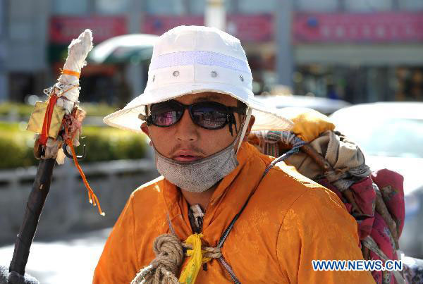 A Lamaist believer, who spent the past month trekking over 300 kilometers to Lhasa, is seen on a street in the capital of Southwest China&apos;s Tibet autonomous region, Nov 14, 2010. [Xinhua]