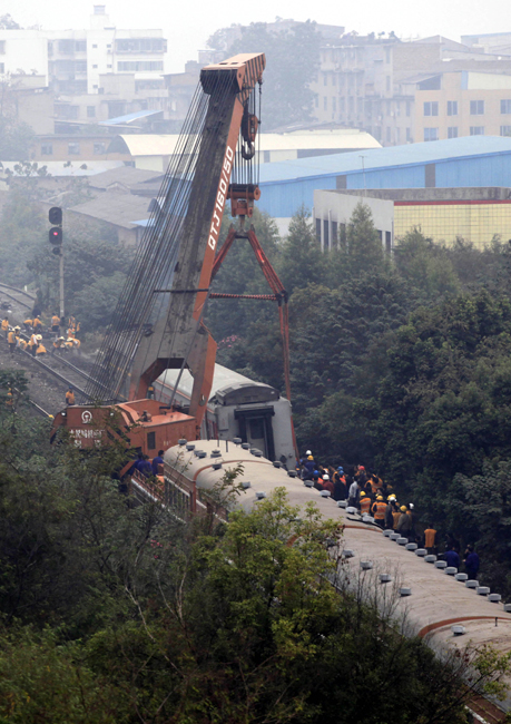 Maintenance workers operate machine to remove the derailed train coach at Liuzhou South Station in Liuzhou City, south China&apos;s Guangxi Zhuang Autonomous Region, Nov. 15, 2010. The fifth coach of the K157 passenger train heading to Zhanjiang City of Guangdong Province from Beijing derailed upon arriving at the Liuzhou South Station at about 3 a.m. Monday. No casualties have been reported, and the investigation of the accident is underway. [Xinhua]