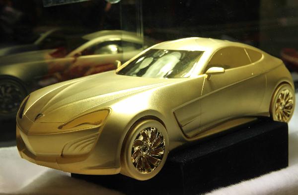 A car model made of gold is exhibited at 2010 China International Jewellery Fair in Beijing, capital of China, Nov. 14, 2010. A variety of gold ornaments with special designs were displayed at 2010 China International Jewellery Fair, attracting lots of customers.