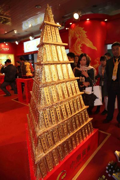 Visitors view gold bars at 2010 China International Jewellery Fair in Beijing, capital of China, Nov. 14, 2010. A variety of gold ornaments with special designs were displayed at 2010 China International Jewellery Fair, attracting lots of customers. [Xinhua photo]