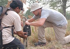 Leonardo DiCaprio fixes a camera trap with WWF staff Pradeep Khanal at Nepal's Bardia National Park. [WWF] 