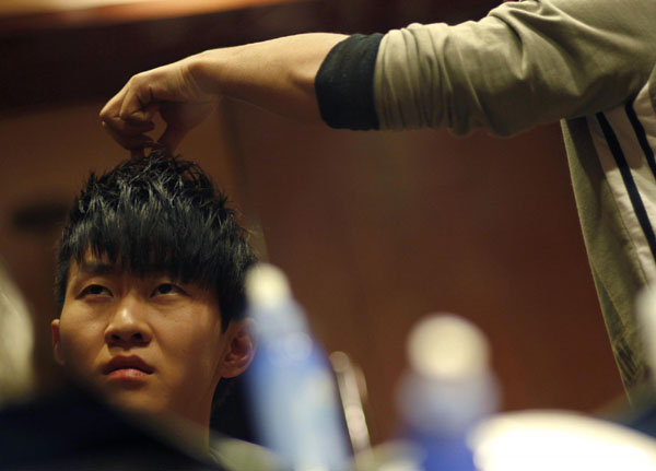 Pianist Liu Wei who is armless, gets his hair done before a promotional performance at a local television channel, in Beijing, Nov 15, 2010. [China Daily/Agencies] 