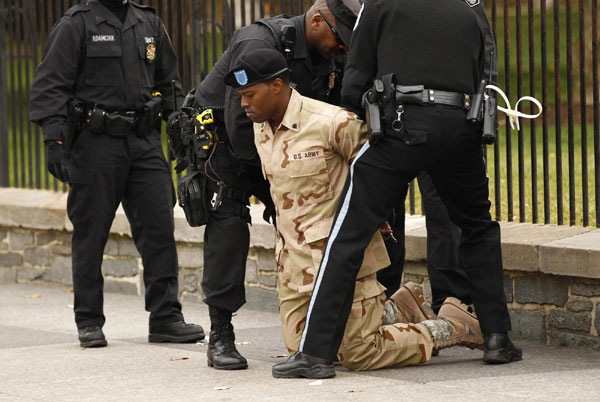 A demonstrator is arrested after handcuffing himself to a fence at the White House in Washington November 15, 2010. Thirteen were arrested here in their protest against the &apos;Don&apos;t Ask, Don&apos;t Tell&apos; law that prevents openly gay men and women from serving in the US military. [China Daily/Agencies]