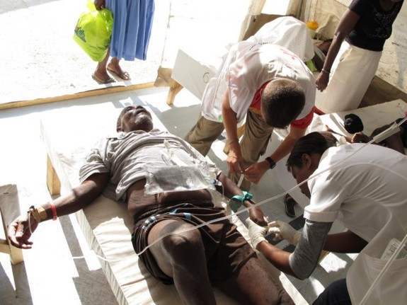 MSF doctors check a cholera patient. [Francois Servranckx/MSF] 
