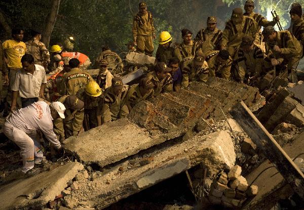 Rescuers conduct rescue operation at the site of building collapse in the Indian capital of New Delhi, on Nov. 15, 2010. As many as 65 people were killed and around 120 others injured when a 15-year-old four-story building collapsed in East Delhi Monday evening, said officials and police. [Xinhua]