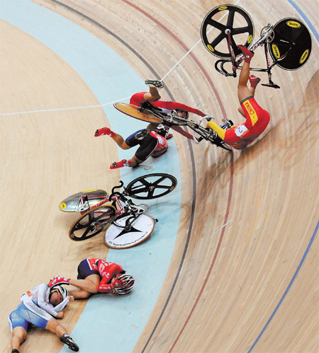 The five race leaders crash heavily on the corner during the women's points race at the 16th Asian Games in Guangzhou on Tuesday. Torsten Blackwood / AFP 