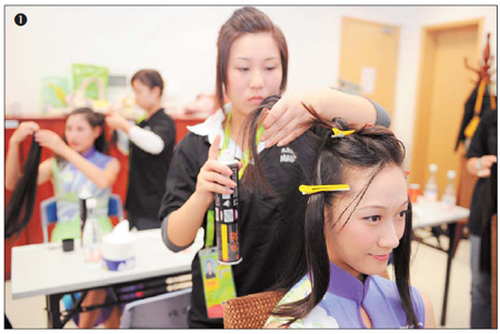  A hostess gets her hair done before attending a medal ceremony. Photos by Agence France-Presse