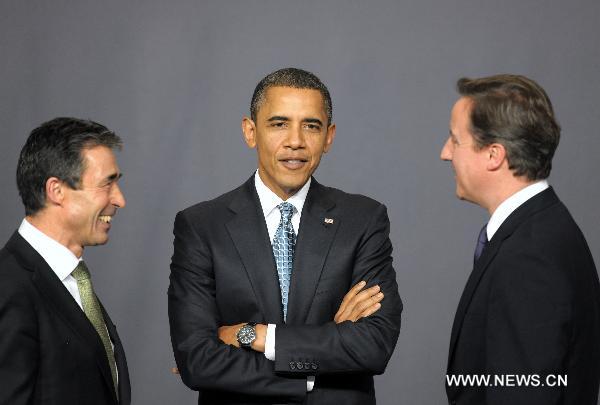 NATO's Secretary General Anders Fogh Rasmussen, U.S. President Barack Obama and British Prime Minister David Cameron (L to R) talk before posing for a group photo at the venue of the NATO summit in Lisbon, capital of Portugal, Nov. 19, 2010. [Wang Qingqin/Xinhua]