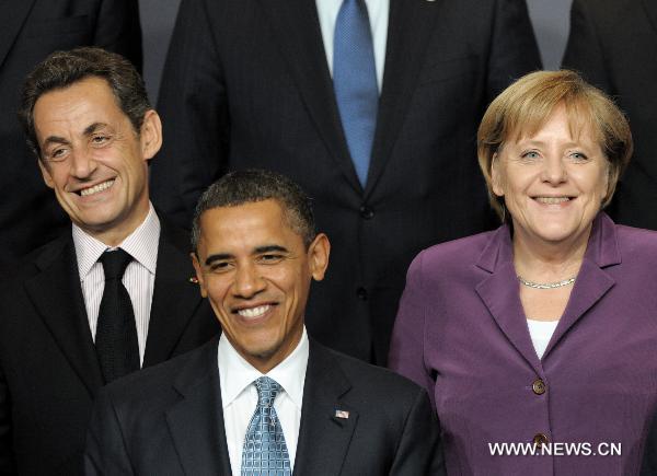 French President Nicolas Sarkozy, U.S. President Barack Obama and German Chancellor Angela Merkel (L to R) pose for a group photo at the venue of the NATO summit in Lisbon, capital of Portugal, Nov. 19, 2010. [Wang Qingqin/Xinhua]