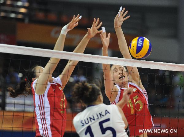 China's Ma Wenwen (R) and Wei Qiuyue block the ball during the women's volleyball Group A preliminary against Mongolia at the 16th Asian Games held in Guangzhou, capital of south China's Guangdong Province, Nov. 14, 2010. China won by 3-0. (Xinhua/Li Qiuchan) 
