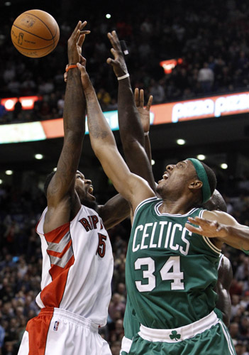 Toronto Raptors Amir Johnson goes up for a rebound against Boston Celtics Paul Pierce (R) during the second half of their NBA basketball game in Toronto, November 21, 2010. (Xinhua/Reuters Photo)