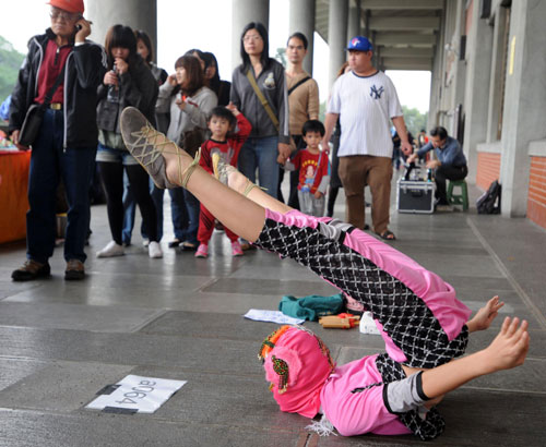 A street artist performs an acrobatic dance at Yixian Park in Taipei, Taiwan, Nov 21, 2010. [Xinhua]