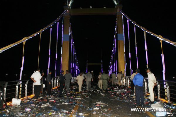Cambodian police officials examine the bridge where a stampede took place in Phnom Penh, Cambodia, Nov. 23, 2010. At least 339 people were killed in a stampede on Monday night as millions of Cambodians celebrated the annual water festival in the capital Phnom Penh, Cambodian Prime Minister Hun Sen said on state TV early Tuesday. The accident took place on a bridge that connects the city with the Diamond Island which has become the center of celebrations. [Xinhua/Phearum]