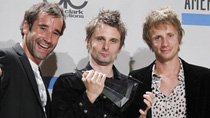 Members of the group Muse pose in the photo room after winning the award for Alternative Rock Music - Favorite Artist at the 2010 American Music Awards in Los Angeles November 21, 2010.