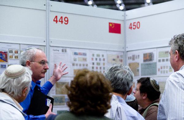 Visitors are attracted by Chinese stamps during the Jerusalem 2010 International Stamp Exhibition, in Jerusalem, on Nov. 22, 2010. 7,000 pages of stamp displays and tens of thousands of philately items, 100 rare stamp collections and unique objects are displayed during the five-day exhibition. [Xinhua photo] 