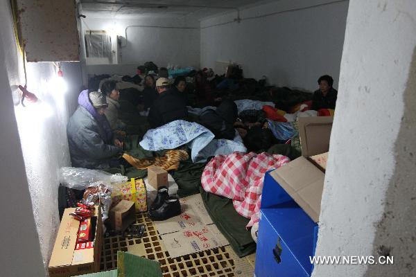 Local residents take refuge in an air raid shelter on the Yeonpyeong Island hit by artillery shells the Democratic People&apos;s Republic of Korea (DPRK) fired a day ago, Nov. 24, 2010. South Korea and the DPRK on Tuesday exchanged fires in waters off the west coast of the divided Korean Peninsula, near the contentious sea border called Northern Limit Line (NLL). [Xinhua]