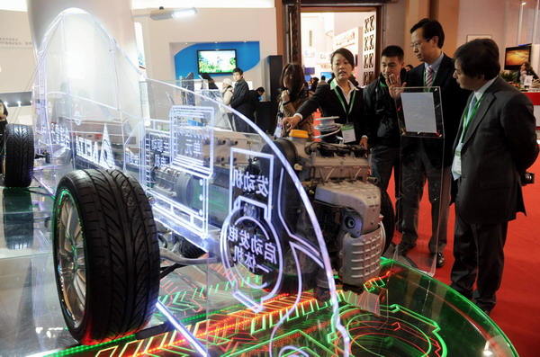 People examine the workings of a plug-in hybrid electric vehicle (PHEV) at the low-carbon technology pavilion of the China International Green Industry Expo 2010 at Beijing Exhibition Center in Beijing, Nov 24, 2010. 