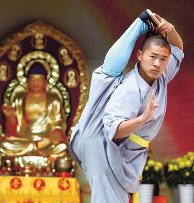 Chen Tao, a 15-year-old monk, practices martial arts at the Shaolin Temple in Dengfeng city, Henan province, in this file photo. 