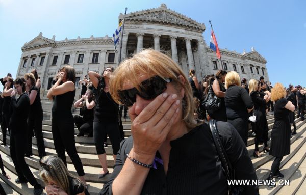 Women participate in a performance during the International Day for the Elimination of Violence against Women, on the stairs of the Parliament, in Montevideo, Uruguay&apos;s capital, on Nov. 25, 2010. [Xinhua]