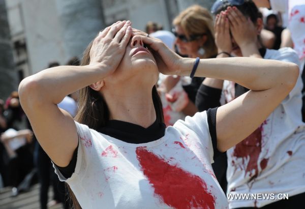 Women participate in a performance during the International Day for the Elimination of Violence against Women, on the stairs of the Parliament, in Montevideo, Uruguay&apos;s capital, on Nov. 25, 2010. [Xinhua]