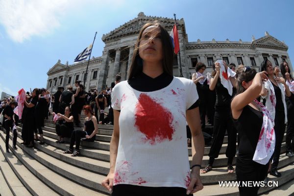 Women participate in a performance during the International Day for the Elimination of Violence against Women, on the stairs of the Parliament, in Montevideo, Uruguay&apos;s capital, on Nov. 25, 2010. [Xinhua]