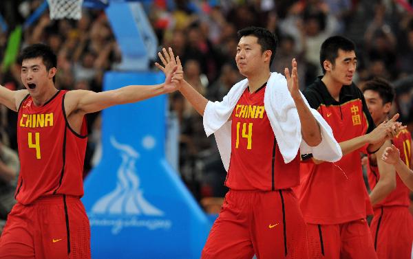 Chinese players celebrate their victory in the men's semifinal of basketball against Iran at the 16th Asian Games in Guangzhou, south China's Guangdong Province, Nov. 25, 2010. China advanced into the final after winning the match 68-65. (Xinhua/Yang Lei)