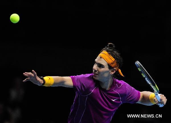 Rafael Nadal of Spain hits the ball towards the stands after his match against Tomas Berdych of Czech Republic in 2010's ATP World Tour Finals in London, Britain, Nov. 26, 2010. Nadal won his third victory in a row by 2-0 to enter the semi-finals. [Zeng Yi/Xinhua]