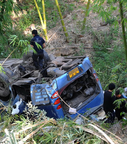 Policemen work at the accident site in Shiping County, southwest China&apos;s Yunnan Province, Nov 28, 2010. Ten passengers were killed and 24 injured after a bus plunged 30 meters down a ravine in Shiping Saturday. [Xinhu]