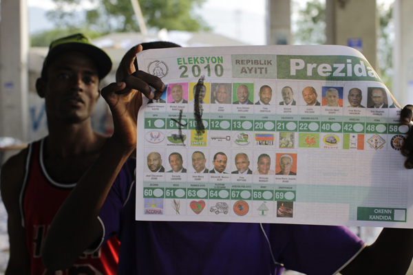 A Haitian shows a vandalized presidential ballot after frustrated voters destroy electoral material during a protest in a voting center in Port-au-Prince November 28, 2010. [Xinhua]